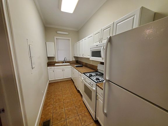 Galley Kitchen with updated appliances and granite countertop
