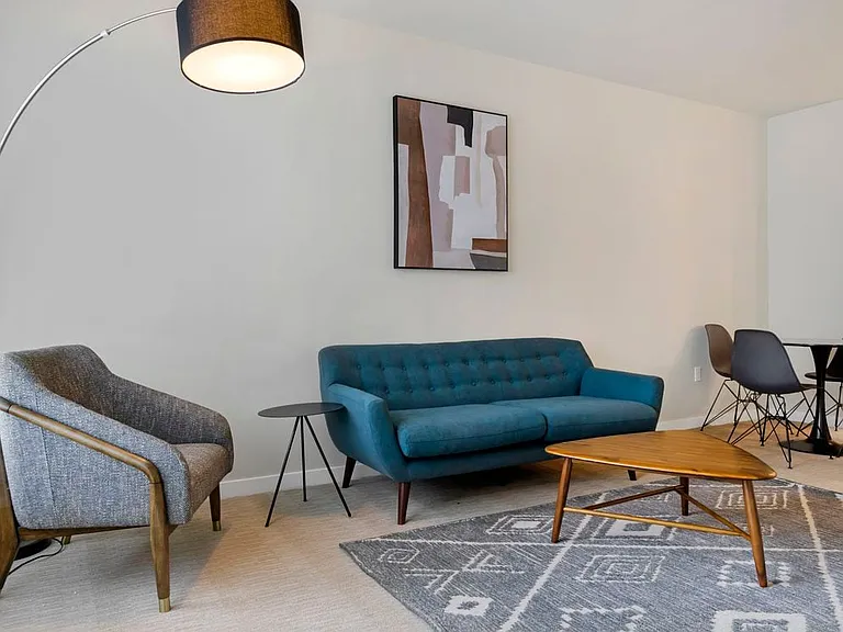 Furnished+ apartment homes come outfitted with a sofa, side chair, side table, coffee table, TV stand and 50" Television (Representative Image exact items and style of furnishings may vary)