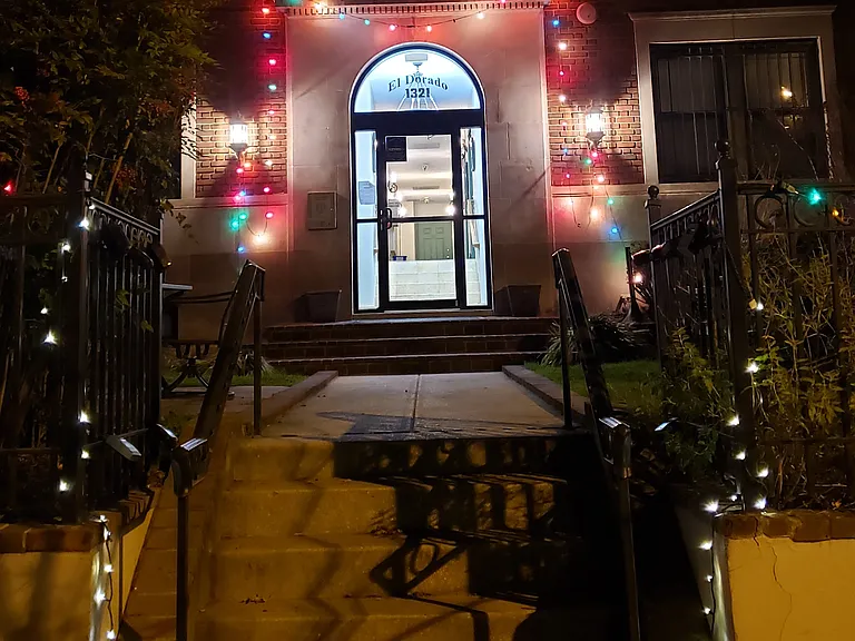 Building front door with holiday lights.