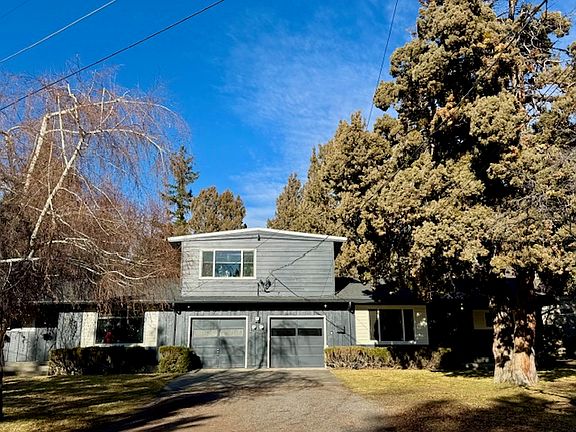 Front view of the triplex. Upstairs is a one bed/one bath, first floor has side-by-side two bed/two bath homes. The lot is surrounded by extensive treed greenspace.