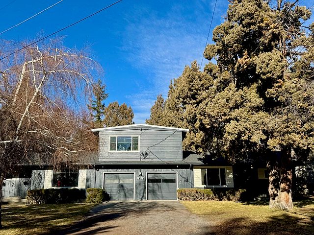 Front view of the triplex. Upstairs is a one bed/one bath, first floor has side-by-side two bed/two bath homes. The lot is surrounded by extensive treed greenspace.