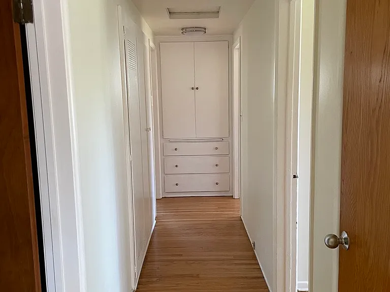 Hallway off main entry leading to bathroom and bedrooms