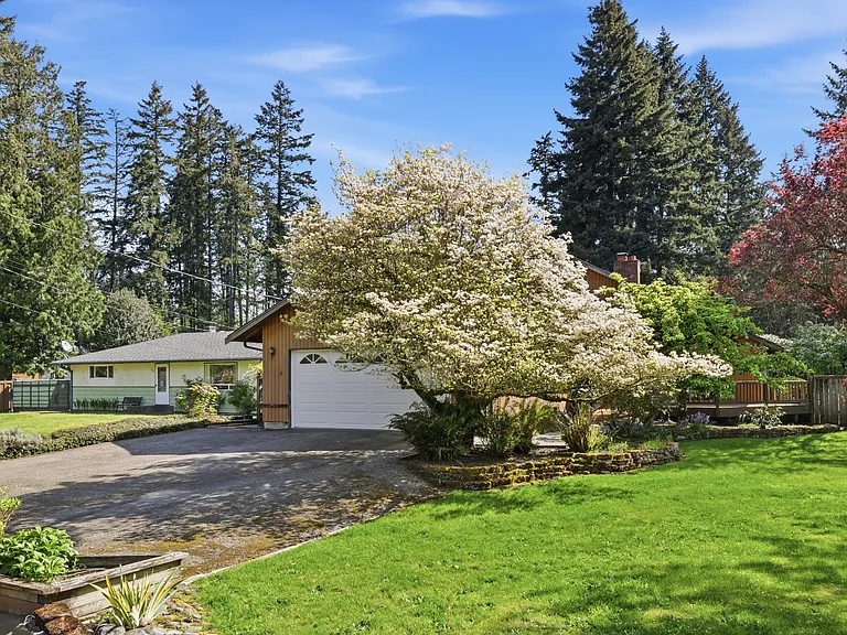 Charming single-level home set back on a nearly half-acre lot with mature, blossoming trees