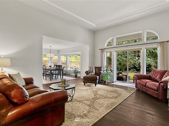Amazing large windows throughout frame the beautiful green outdoors! >>Love the tray ceiling!