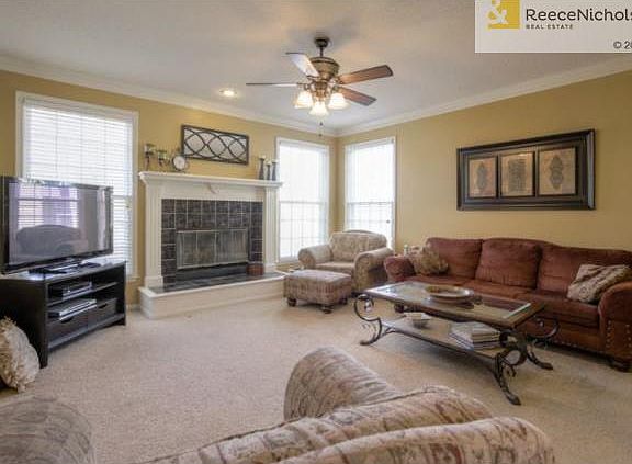 The Great Room offers crown molding, ceiling fan, 3 windows and