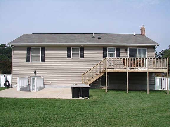 rear view w/deck and backs to woods