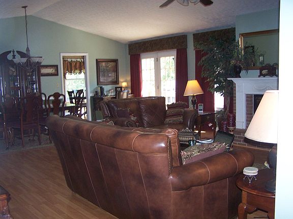 Living room with cathedral ceiling and custom drapes
