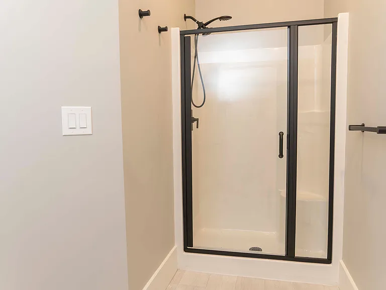Walk-in shower, glass, handheld showerhead.
