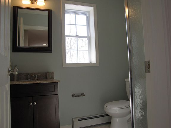 1st floor bathroom with granite countertop and custom tile in the shower