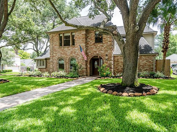 Follow the paved concrete path through the center of the front lawn to the lovely front porch.