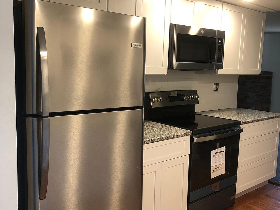 Kitchen with granite countertops & white shaker cabinets