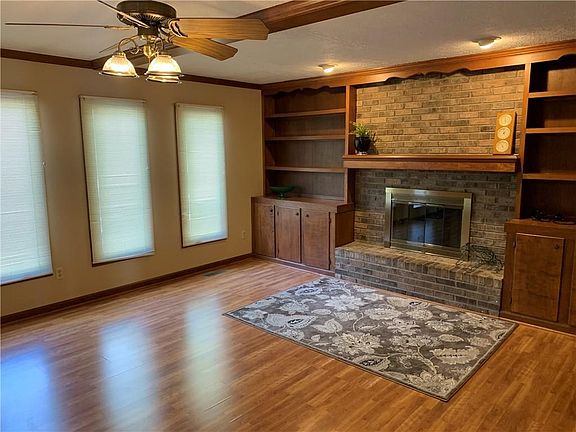 The Family Room features built in bookcases, and a fireplace with raised hearth