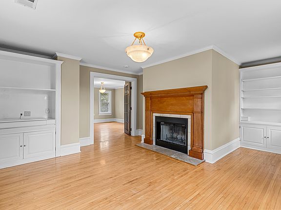 Beautiful hardwood floors, working antique wood fireplace, and built-in shelving.