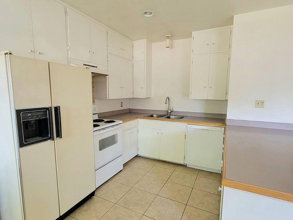 Kitchen area with dishwasher, garbage disposal, refrigerator and stove. Large island counter.