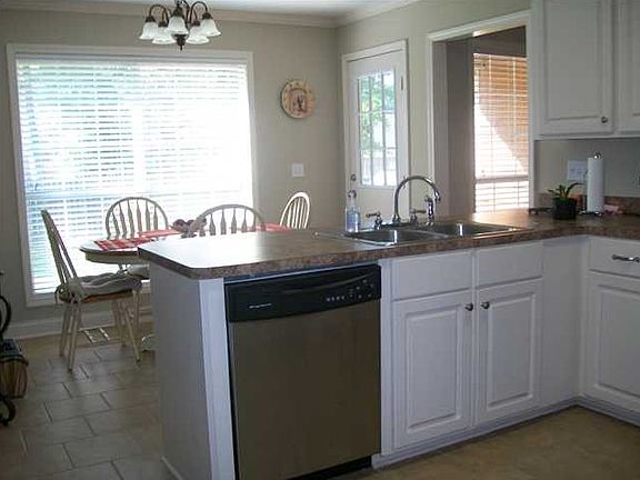 Kitchen with breakfast bar and stainless appliances.