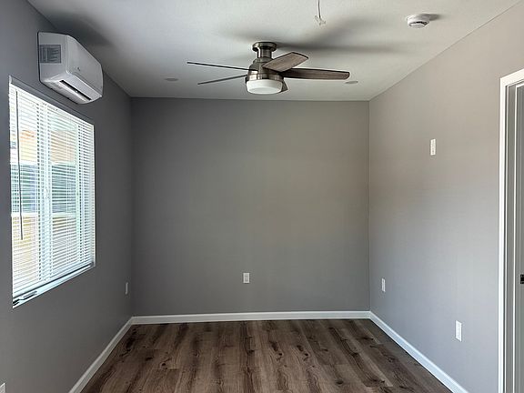 Living room with ceiling fan and mini split AC system