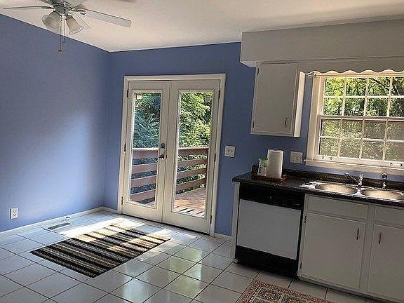 Kitchen opens onto private deck and large treed back yard.