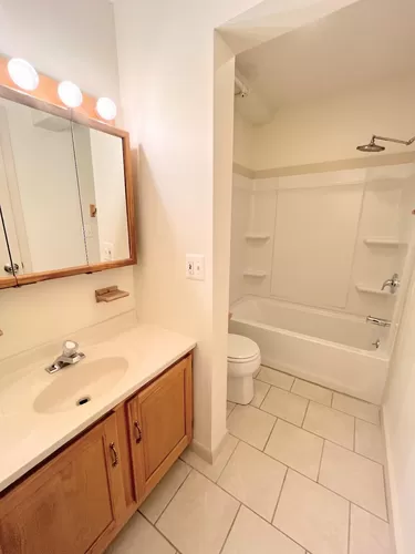 The full bathroom with a vanity, toilet, and full tub/shower. - 190 Northwood Dr #C9