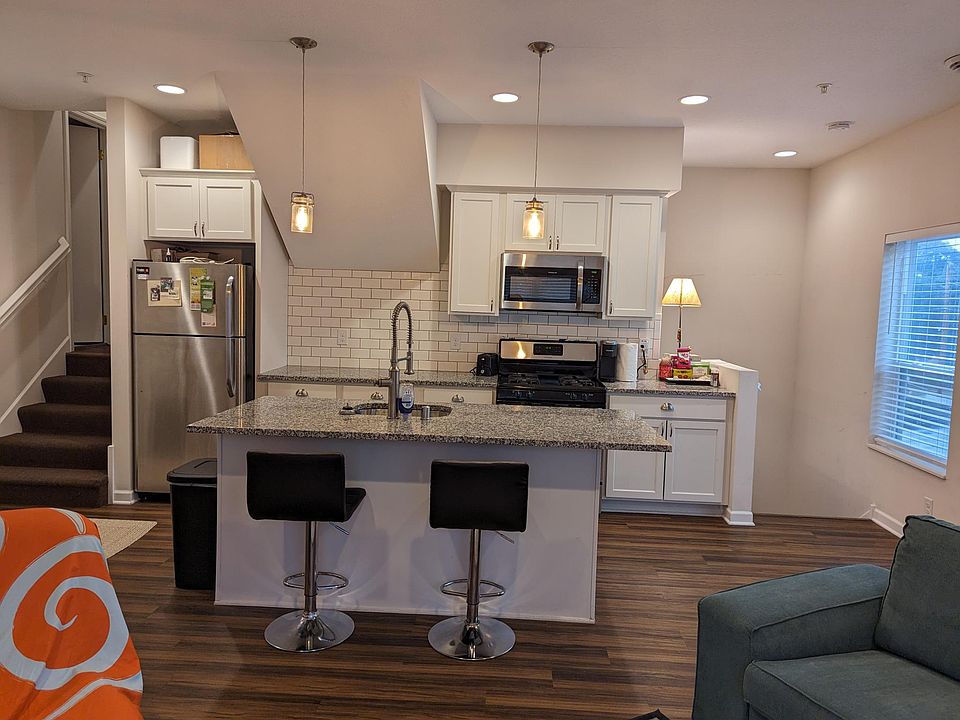 Full kitchen with stainless steel appliances.