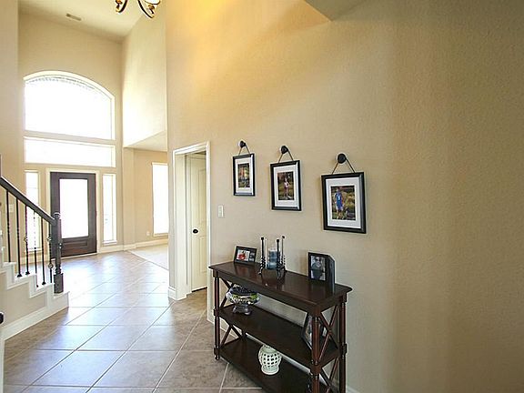 AWESOME TWO STORY ENTRANCE LEADS INTO THE LIVING ROOM
