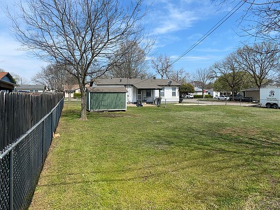 Large Backyard looking from the back of the property towards the home. Storage shed (pictured left) by tree.