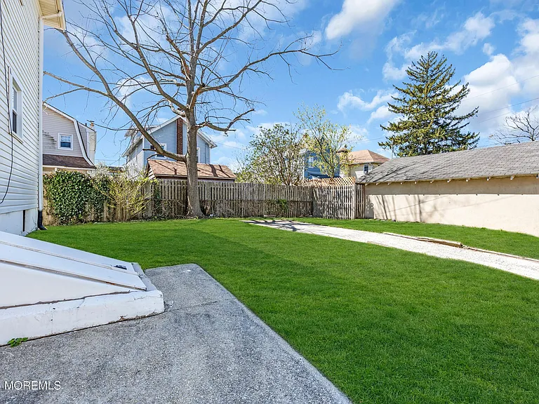 Shared backyard with green lawn