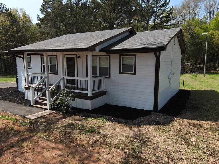 Front porch with lots of shade from the large oak tree and newly installed composite deck and stairs.