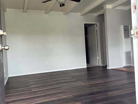 Living Room With Ceiling fan . Entire unit freshly painted.