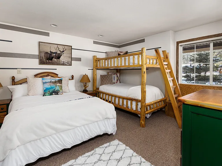 Downstairs large guest room with private bathroom/shower. Thick Pine Bunk with 2 twin beds and stand alone Queen bed w/ Smart TV