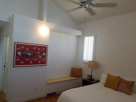 Master Suite with vaulted ceilings, king size bed, seating area, XL closet