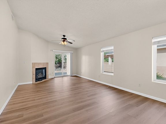 Expansive open concept living room with plenty of natural light from the two windows, gas fireplace and dining area directly off the kitchen. Vaulted ceilings give the space elegance.