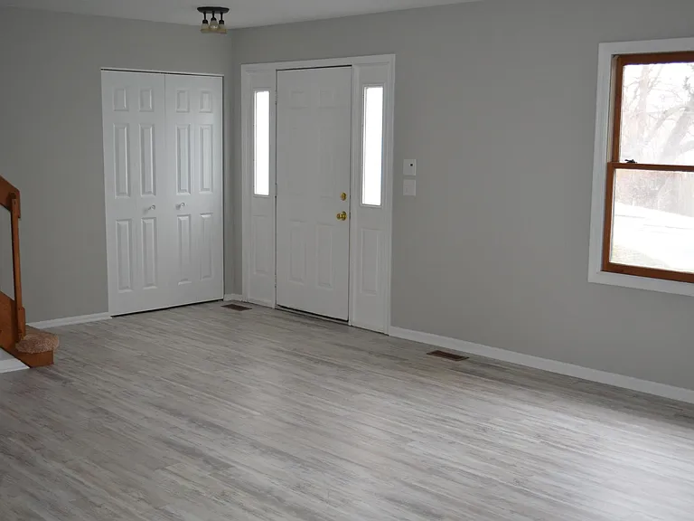Entry way & Living room/Family Room. Guest closet.
