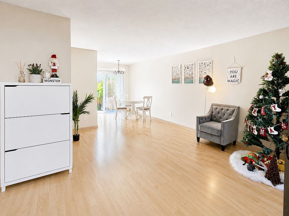 Welcoming first-floor living room with an open layout, warm wood flooring, and easy flow into the dining area.