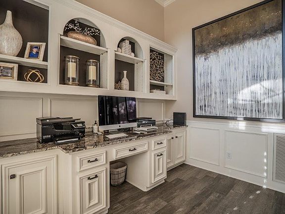 This home office has it all! Granite, built in storage, plantation shutters and a beautiful floor!
