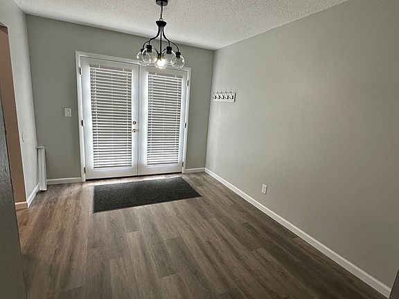 Dining room 10' x11', new vinyl plank flooring with a new French door on to fenced patio