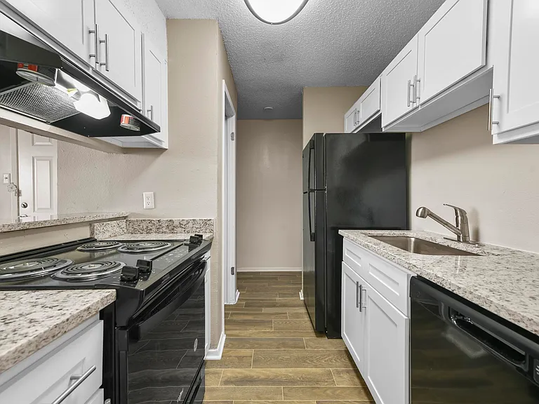 Updated kitchen with black appliances and beautiful granite counter tops