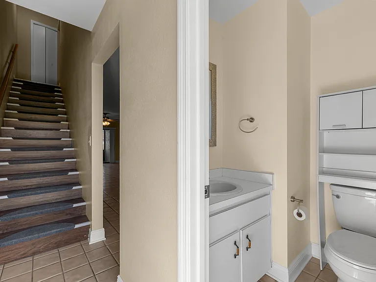 View of the downstairs bathroom and stairs going to the bedrooms