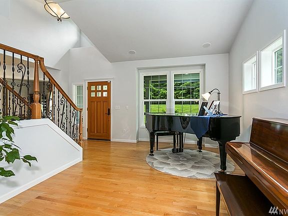 Front room with tons of natural light.  Notice the custom stair railing. 