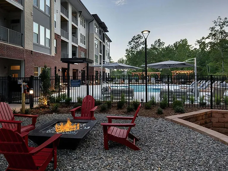 Outdoor Fire Pit Lounge with Adirondack Seating and Pool Views