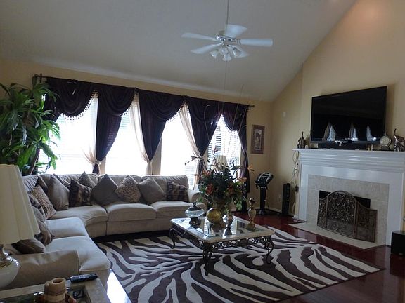 The Den Has Hardwoods and Lots of Windows to View the Backyard and POOL