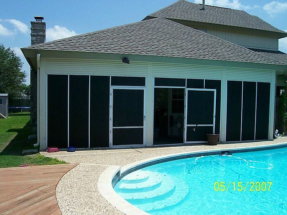 Enclosed Florida room connected to wraparound porch