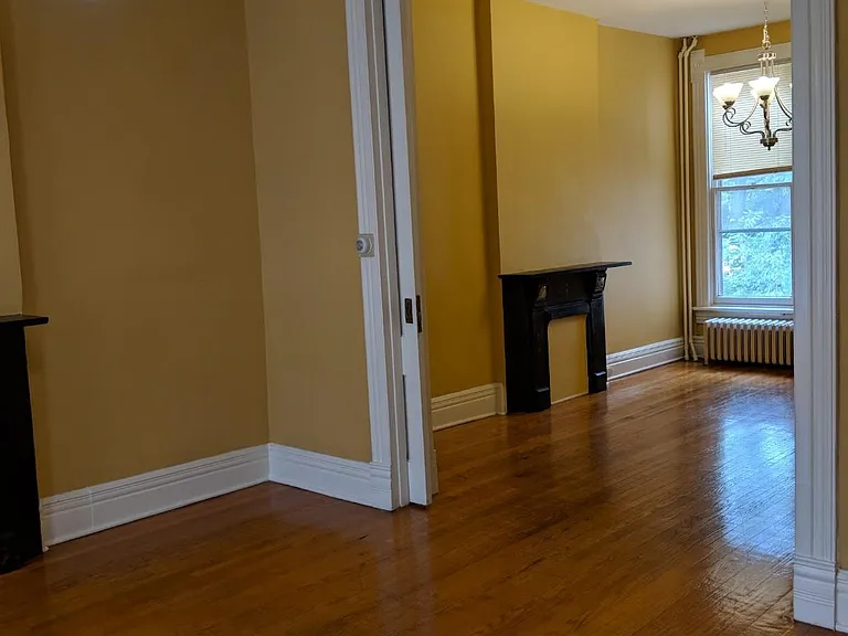 from living room with old light fixture looking into living room/pocket doors can separate spaces