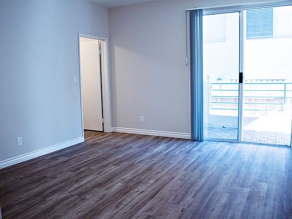 View into Master Bedroom with balcony access & walk-in closet (2nd walk-in closet and ensuite bath to the left)