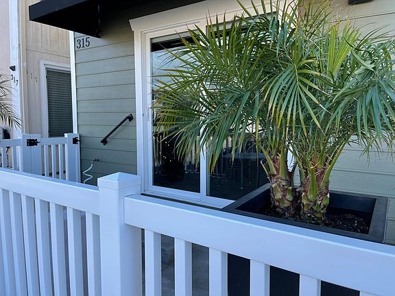 Another photo of the front porch patio. Patio has access off of the side walkway as well as directly from the unit via the sliding glass door shown in this photo.