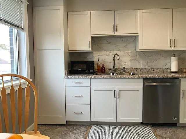 Cabinets new as of recent remodel. Very light and bright both day and night. Can lighting in ceiling, large window, beautiful countertop lighting, as well.