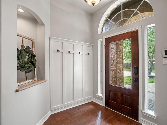 Look at that adorable hanging rack! This home has so many beautiful touches you will fall in love with! Throughout the home there are many art niches with curved architecture giving the home a classic look.