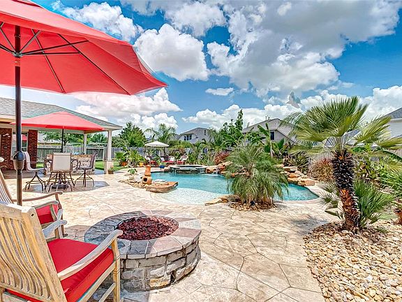 Relax by the fire pit while your guests swim and enjoy your fantastic backyard.