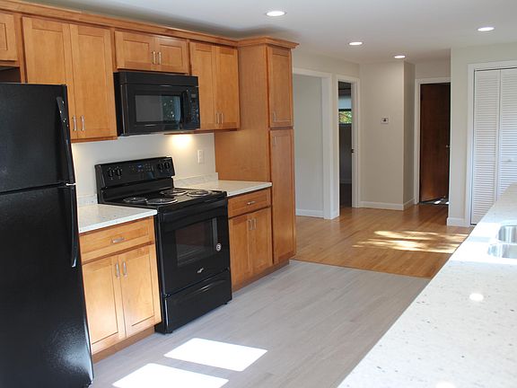 Fully remodeled kitchen with new appliances, granite countertop and tile floor.