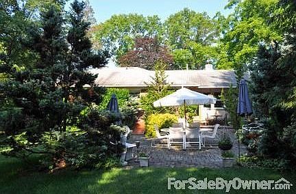 corner property on country lane : large yard with stone patio leading to a charming covered porch an