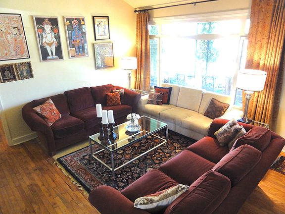 Living room with huge front window looking out on lawn and t